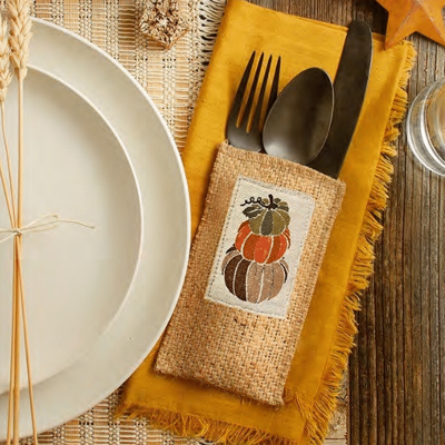 Cutlery Couture stacked pumpkin silverware pouch on an autumn table setting.