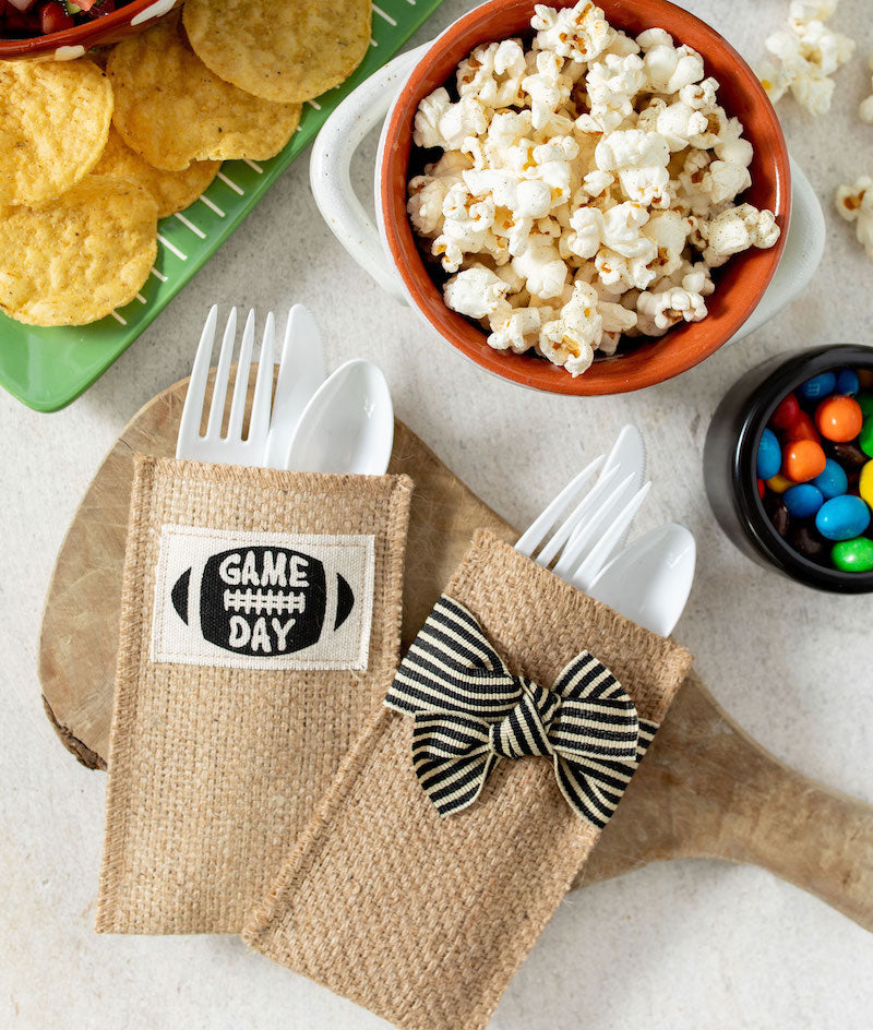 Cutlery Couture Game Day and striped ribbon silverware pouches with football party snacks.